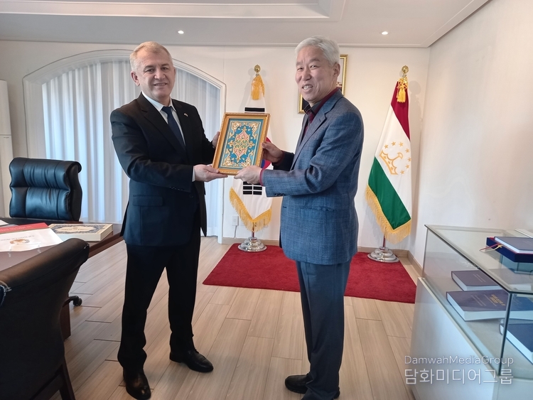 Amb. Salohiddin Kirom of Tajikistan (left) presents a gift to Lee Jon-young, chairman of Diplomacy Journal.