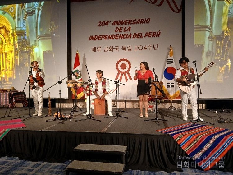 Four musicians are playing traditional Peruvian music for guests at a reception.