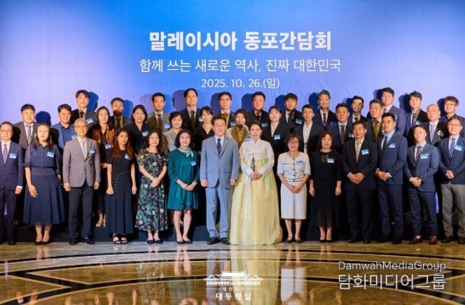 President Lee Jae-myung takes a commemorative photo with participants in a dinner meeting with Koreans in Malaysia on October 26, 2025.